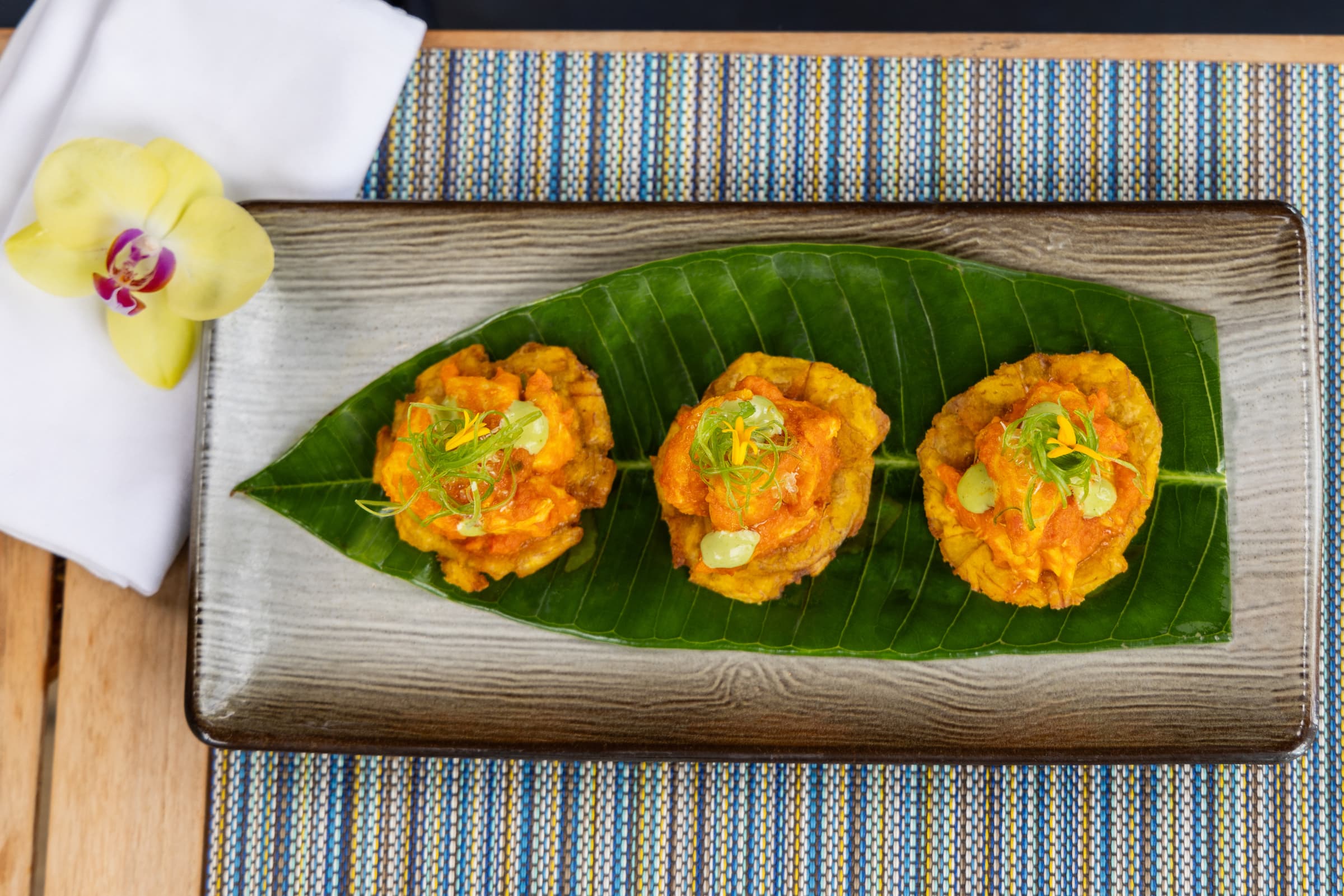Three curry battered shrimp on a coconut leaf served from the restaurant at Little Palm Island