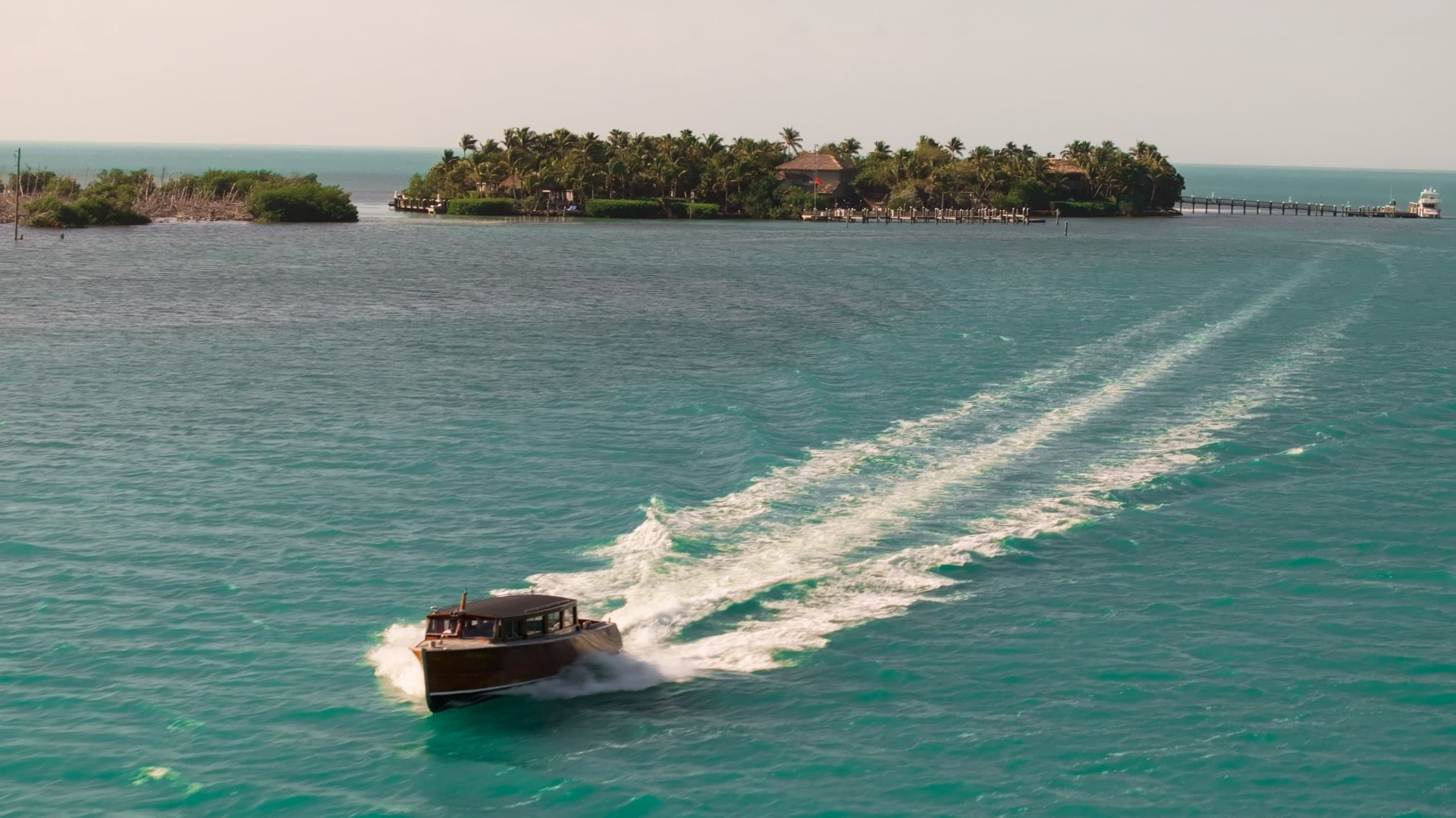 A private yacht leaving the docking marina at Little Palm Island Resort
