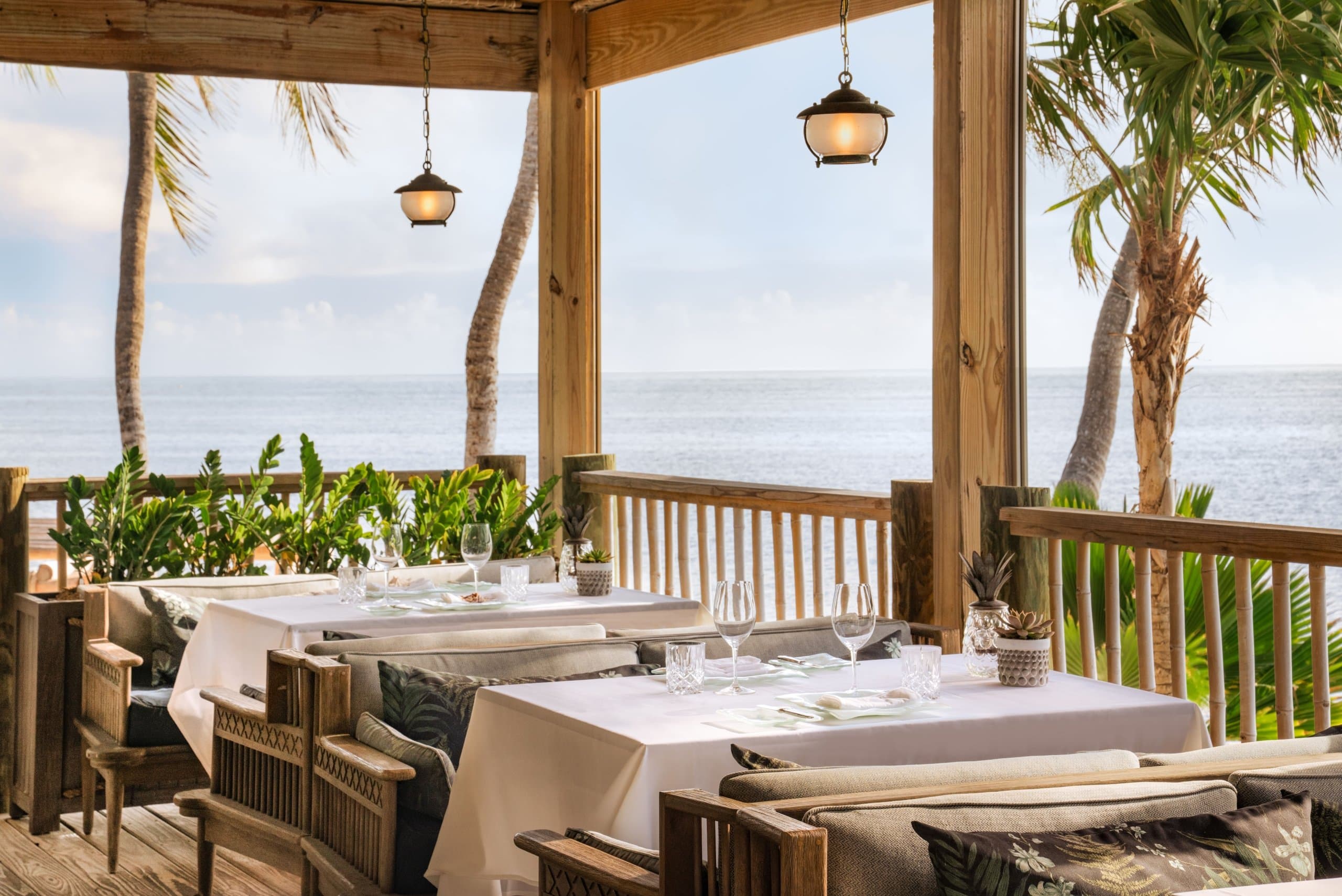 Oceanfront outdoor dining area at Little Palm Island Resort
