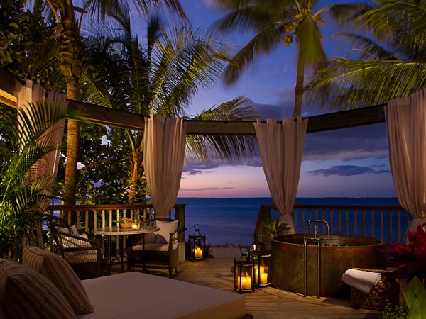 Romatic suite deck by the ocean at sunset.