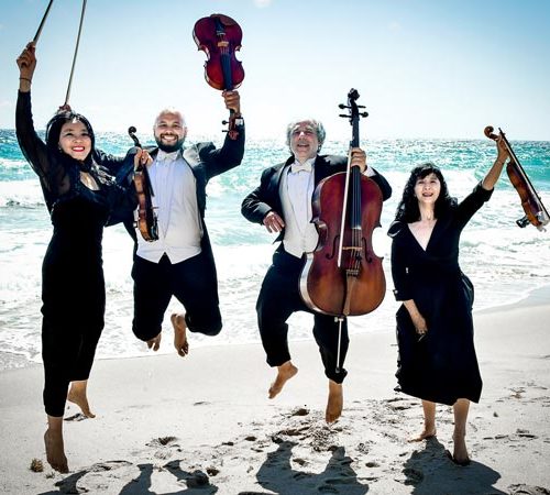 String Quartet Jumping On The Beach.