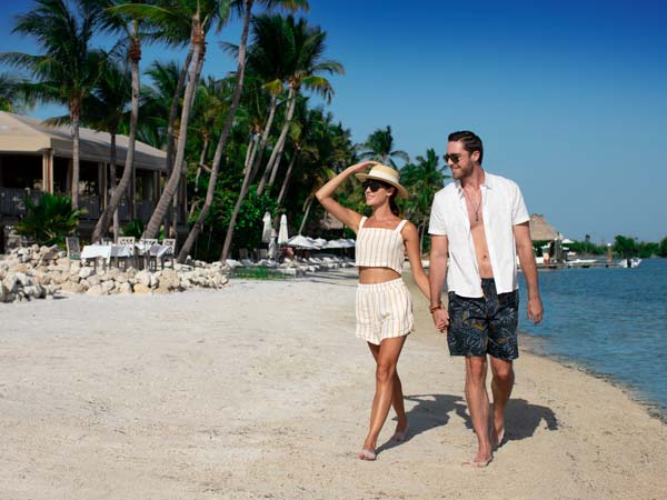 Couple Walking On The Beach.