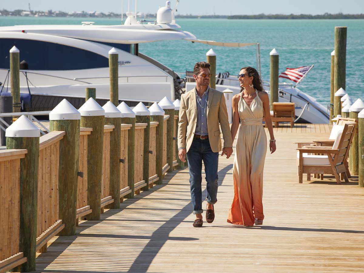 Couple Walking Along The Little Palm Island Pier.