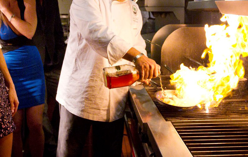 Chef cooking a dish with brandy